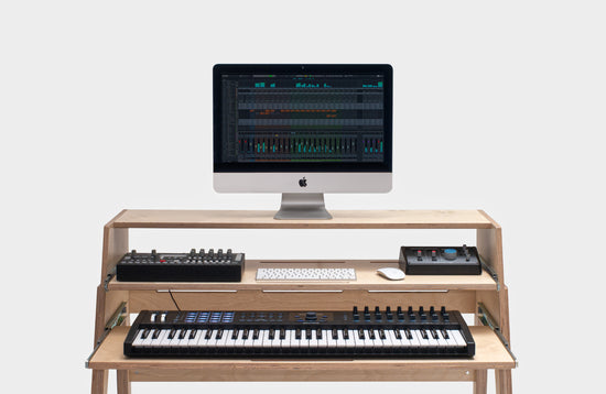Compact One studio desk with dual keyboard trays for small spaces